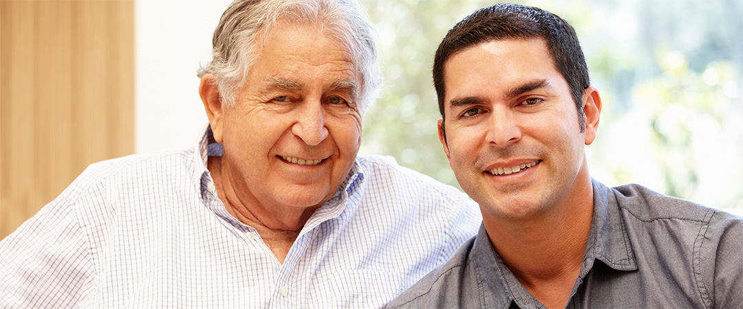 older and younger man seated close together