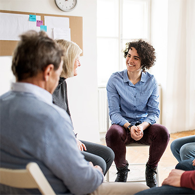 several people talking in a circle during therapy